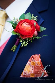 a man in a suit and tie with a boutonniere on his lapel