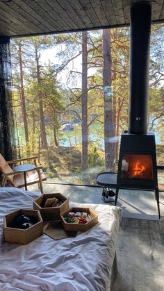 a bed in front of an open fire place with two boxes of food on it