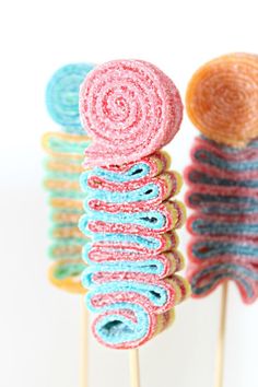 colorful lollipops are sitting on top of each other