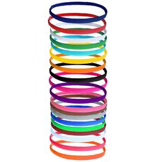 a stack of different colored bracelets sitting on top of each other in front of a white background