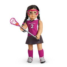 a doll is holding a tennis racquet and wearing a pink uniform with numbers 2 on it