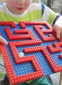 a child is holding a toy made out of legos and it looks like he's playing with the letters