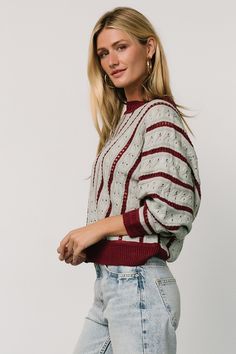 Elevate your style with the Paola Pointelle Sweater, featuring light blue with burgundy diagonal stripes. This relaxed fit sweater boasts a round neck, dolman sleeves, and patterned ribbing at the cuff, collar, and wide ribbed hem. Fall Striped Cable Knit Sweater, Striped Pointelle Knit Tops For Fall, Burgundy Knit Sweater For Layering, Winter Striped Pointelle Knit Sweater, Pointelle Sweater, Pointelle Knit, Diagonal Stripes, Sweater Material, Feature Light