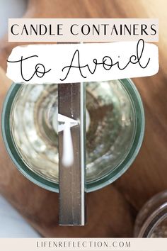 a wooden table topped with a glass jar filled with liquid and a sign that says candle containers to avoid