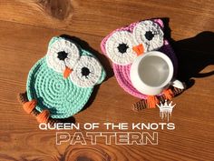 two crocheted owls sitting next to each other on top of a wooden floor