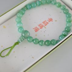 Green Banded Agate Bracelet Characteristics of the product Material : Green Banded Agate, Silk elastic cordWrist size : about 17cm (Stretch)We adjust the size to your wrist for a fee.Head beads : about 10mmMain beads : about 7mm Handmade in Kyoto, JAPAN About Green Banded Agate Green agate is considered a healing stone with a multitude of properties. It is believed to dispel negative energies, boosting self-confidence and self-esteem. It is also associated with health, luck, harmony, beauty, and Meditation Jade Bracelet With 108 Beads, Agate Bracelet With 108 Beads, Adjustable Jade Jewelry For Meditation, Handmade Jade Bracelets For Meditation, Hand-strung Jade Crystal Bracelet For Meditation, Spiritual Jade Crystal Bracelet With Gemstone Beads, Agate Gemstone Beads Crystal Bracelet As Gift, Agate Meditation Bracelets With 108 Beads, Agate Bracelets With 108 Beads For Meditation