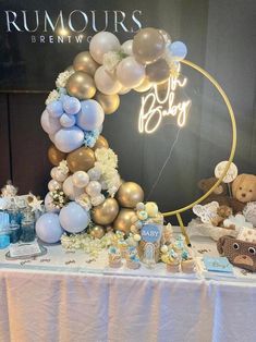 a table with balloons and teddy bears on it for a baby's first birthday