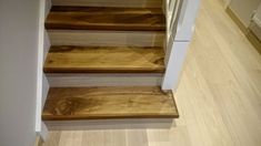 the stairs are made of wood and have white trim