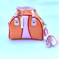 Urban Outfitters Sydney Bowler Crossbody Mini Bag Vegan Leather Orange Pink Nwt [Item Has A Line Through Name To Prevent Return To The Store But Is New.] Mini Bowler-Style Handbag Designed In Orange And Pink Croco Faux Leather. Fitted With Faux Leather Fixed Handles, A Detachable Strap And A Zipper Closure. - 100% Polyurethane - Spot Clean Size - Length: 8" - Width: 4.25" - Height: 6.5" - Strap Drop: 12”-24” - Handle Drop: 3.5" Please Contact Me With Any Questions Or If You Need Any Additional I Rattan Handbags, Pink Crossbody Bag, Leather Sling Bag, Small Crossbody Purse, Croc Leather, Leather Belt Bag, Black Leather Crossbody Bag, Orange And Pink, Orange Leather