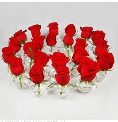 a bunch of red roses sitting in a vase