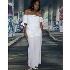 White Linen/Polyester, Off The Shoulder, Wide Leg Jumpsuit With Self Tie Detail On Sleeve. Two Pockets And Decorative Tie Around Waist. Off Shoulder Jumpsuit, White Off Shoulder, White Jumpsuit, Fashion Updates, Wide Leg Jumpsuit, White Linen, Pant Jumpsuit, Jumpsuit Romper, Off The Shoulder