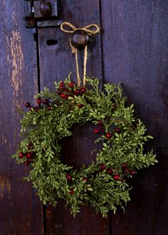 a christmas wreath hanging on a wooden door