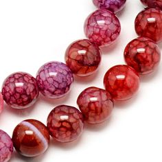 red and pink glass beads on white background