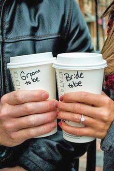 two people holding coffee cups with the words bride and groom written on them in cursive writing