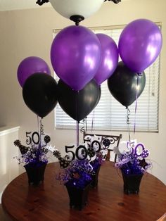 purple and black balloons are on the table