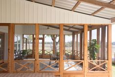 an open porch with wooden railings and glass doors