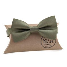 "This bow tie is the perfect addition to any wardrobe.  Fabric: blend The strap is adjustable up to size XXL (19 1/2\") and features metal hook, eye and slide hardware in nickel.  All bow ties are shipped with a gift box. Dry clean or spot cleaning only. Please note that I try my very best to represent my bow ties as accurately as possible; however, the colour(s) of each bow may vary slightly depending your screen. For more information, photos and updates please follow me here: Instagram: https: Adjustable Satin Bow Tie In Dapper Style, Dapper Adjustable Satin Bow Tie, Classic Green Adjustable Suit And Tie Accessories, Green Adjustable Tie For Party, Adjustable Green Tie For Party, Adjustable Green Ties For Party, Classic Green Bow Tie For Gifts, Green Adjustable Suit And Tie Accessories For Black Tie, Green Bow Tie For Gifts