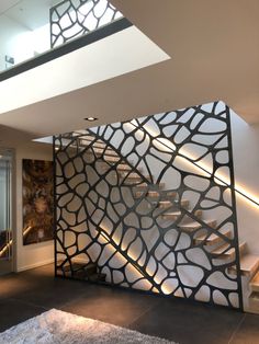 a room divider in the shape of a rock pattern with stairs leading up to it