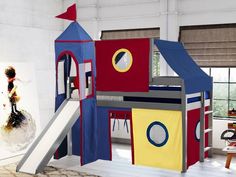 a child's play house with a slide and climbing tower in the middle of it