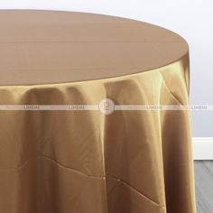 a round table with a gold cloth on it