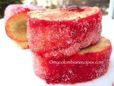 two pieces of cake sitting on top of a white plate covered in powdered sugar