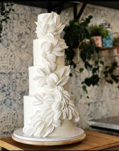 a three tiered white cake with flowers on it