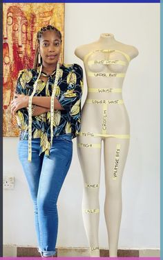 a woman standing next to a mannequin with tape on it's sides