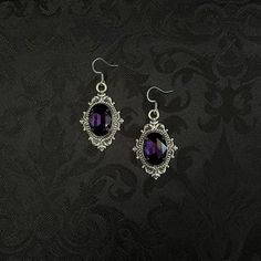 "These richly detailed earrings are made with antiqued silver tone settings. Their captivating design is accented with dark amethyst purple glass jewels.  Earrings measure 2\" in length (including stainless steel hooks) and 1\" wide.  Matching chokers are listed separately in our store. If you don't see items with a color you want, feel free to ask about availability." Black And Purple Vampire Aesthetic, Dark Purple Jewelry Aesthetic, Purple And Black Earrings, Purple Accessories Jewelry, Purple And Black Jewelry, Purple Prom Accessories, Victorian Style Silver Earrings With Antique Finish, Ornate Silver Earrings With Antique Finish, Gothic Purple Metal Jewelry