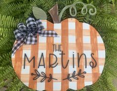 a wooden sign that says the marvins on it with leaves and branches around it