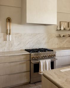 a stove top oven sitting inside of a kitchen