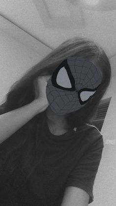 a woman with a spiderman mask covering her face