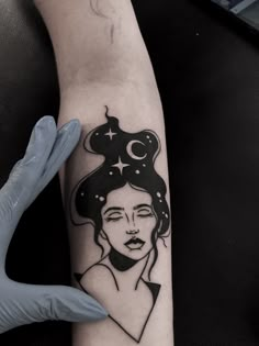 a woman's arm with a tattoo on it and a star above her head