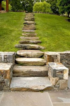 stone steps leading up to the top of a grassy hill