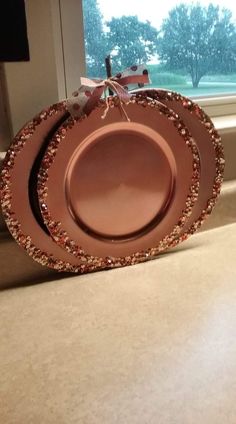 a brown plate sitting on top of a counter next to a window