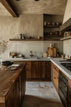 a kitchen with wooden cabinets and white counter tops is pictured in this image, there are pots on the shelves above the stove