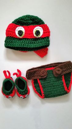 two crocheted hats and booties are on the table