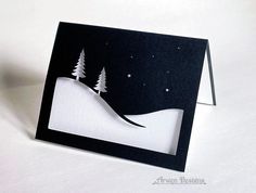 a black and white card with trees on it