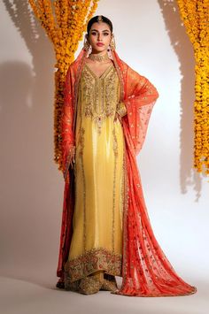 Yellow Mehndi Dress in Kameez Trouser Dupatta Style Floor-length Raw Silk Dupatta With Naqshi Detail, Festive Traditional Wear With Naqshi For Reception, Anarkali Naqshi Gown For Festivals, Traditional Floor-length Gown With Naqshi Detailing, Yellow Dupatta With Dabka Work For Reception, Traditional Wear With Naqshi For Diwali Reception, Gold Dabka Dress For Reception, Wedding Gown With Naqshi For Festivals, Gold Dabka Reception Dress