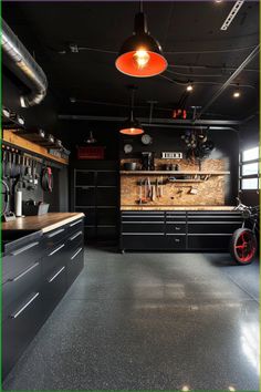 the garage is clean and ready to be used as a work area for cars or motorcycles