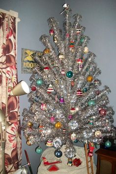 a silver christmas tree sitting on top of a table