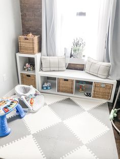 a playroom with toys and storage in it