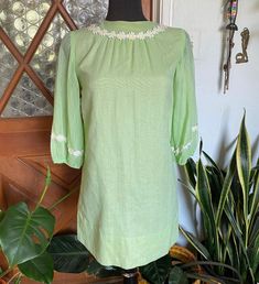 "Vintage 60s key lime mini dress. No tags. Zips up the back with sheer balloon half sleeves. Adorable daisy details.  Excellent vintage condition! No stains or holes. Zipper works great! Size: not tagged. Best fit 2-6. Always refer to measurements for more accurate sizing. Measurements taken laying flat/Double number where applicable: SHOULDER TO SHOULDER: 16\" - very important measurement ARMPIT TO ARMPIT: 18\" across max  HIP: 19\" across SLEEVE: 12\" inseam, 9.5\" width LENGTH: 31\" Message me if you need any other measurements.  ALL SALES ARE FINAL SO PLEASE DOUBLE CHECK THE MEASUREMENTS PRIOR TO BUYING AND DON'T HESITATE TO REACH OUT IF YOU HAVE ANY QUESTIONS!  All items are vintage/preloved and may have small imperfections. This should be expected for secondhand clothing. ALL MAJOR F Vintage A-line Mini Dress For Spring, Vintage Green Long Sleeve Mini Dress, Vintage Green Puff Sleeve Dress, Vintage Green Dress With Puff Sleeves, Light Green Short Sleeve Spring Dress, Light Green Short Sleeve Dresses For Spring, Vintage Short Sleeve Mini Dress For Summer, Retro Puff Sleeve Mini Dress For Summer, Vintage Knee-length Spring Mini Dress