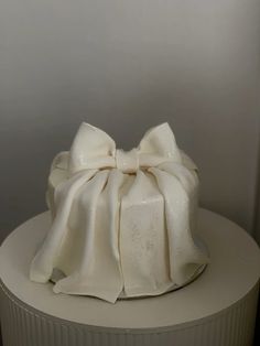 a white cake with a bow on top