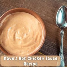 a bowl filled with sauce next to a spoon on top of a wooden table and the words, dave's hot chicken sauce recipe