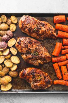 chicken, potatoes and carrots on a baking sheet with a red frame over it