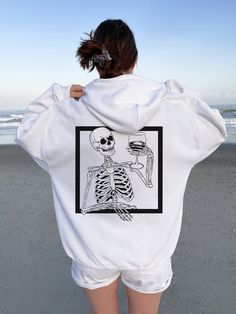 "Y2K Skeleton Hoodie Horror Hoodie Skull Hoodie Goth Hoodie Halloween Hoodie Halloween Sweaters Halloween Shirt Halloween Sweater ➭ How to Order 1. Choose your sweatshirt size & color options. 2. Select the quantity. 3. Click \"Add to Cart.\" 4. Listen for a knock at your door! ➭ Care Instructions Wash your shirt in warm water. Bleach if needed. Do not dry clean or iron directly on the design. Tumble dry on medium. ➭ Production & Shipping Processing typically takes 1-3 days. Depending on where y Oversized Hip Hop Hoodie For Halloween, Oversized Halloween Hoodie With Graphic Print, Hip Hop Hoodie With Skull Print, Oversized Graphic Print Hoodie For Halloween, Punk Halloween Hoodie Sweatshirt, Halloween Streetwear Hoodie, Hip Hop Halloween Hoodie With Graphic Print, Halloween Hoodie With Crew Neck For Streetwear, White Punk Hooded Sweatshirt