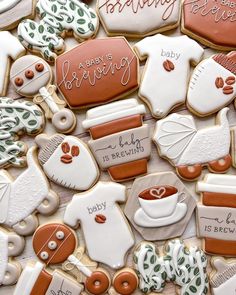 cookies decorated with baby items are displayed on a table