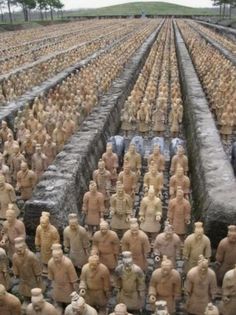 rows of clay figurines are lined up in rows, and there is no image to describe