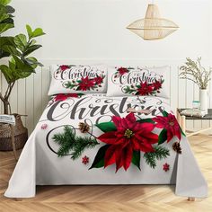 a christmas themed bed with poinsettis and pine cones