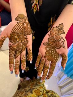 a woman's hands with hennap on her hand and the bottom half of her arm